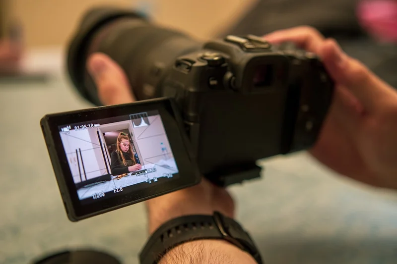 a person holding a camera up to take a picture